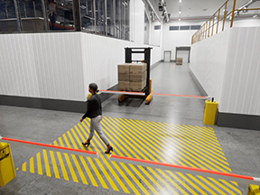 Pedestrian walking across a striped walkway as a loaded forklift waits behind a red forklift gate arm