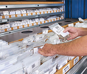 worker accessing small parts at a VLM window