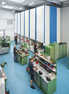 workers in a repair operation using carousel for parts