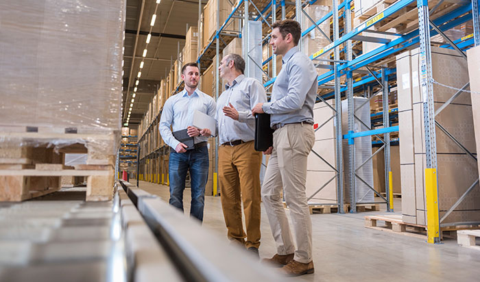 Warehouse planning session near conveyor system