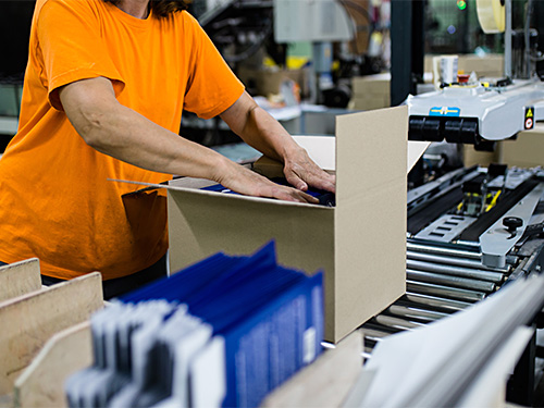 worker packing order at end of conveyor line
