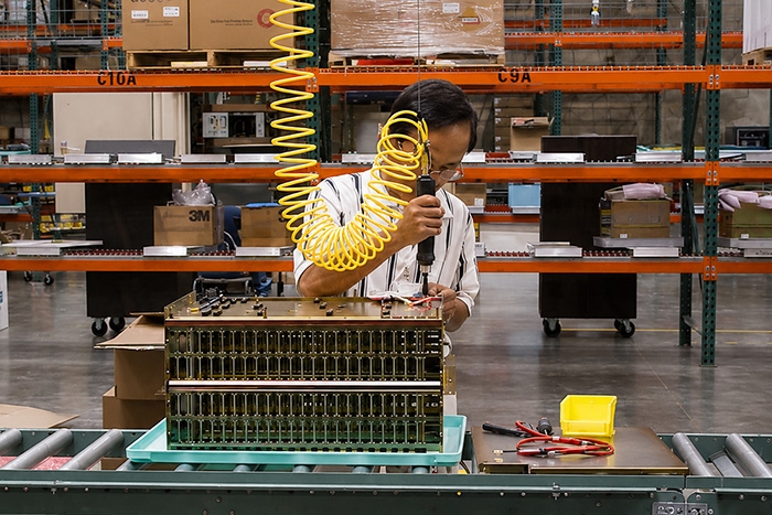 Tool balancer and conveyor line for telecommunications component manufacturing