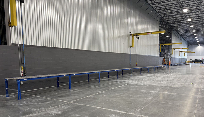 conveyor line below cranes in manufacturing site 