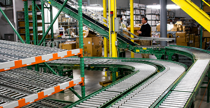 Conveyor line integration with high density carton flow system