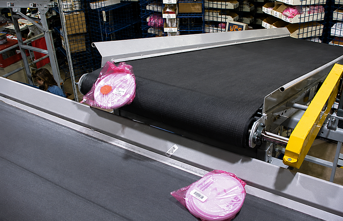 Waterfall effect of electronics bag moving from pick module to takeaway line.