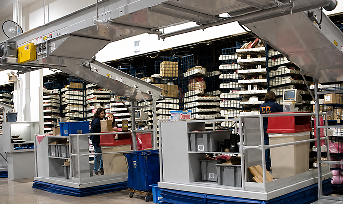 Picking from carousels to incline takeaway conveyor lines