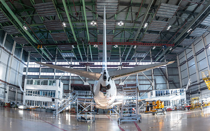 Aerospace MRO hangar with a jet in service