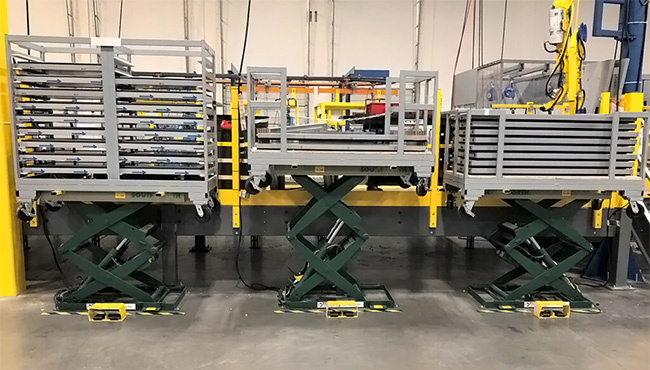 three lift tables holding work in process