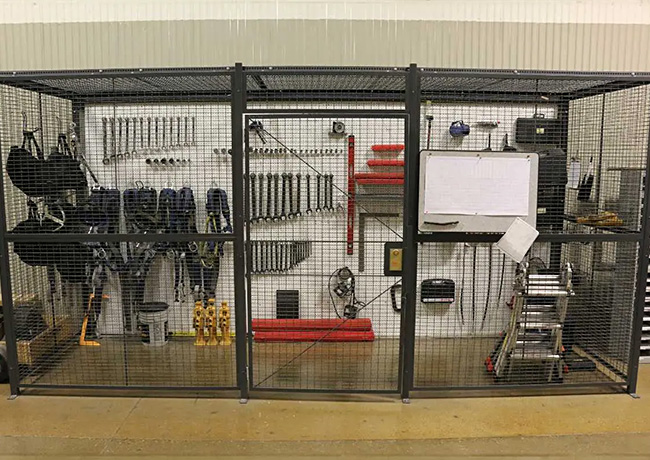 tools and equipment stored behind wire partitions with lockable gate