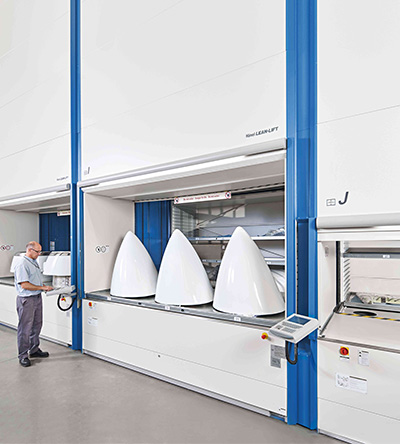 worker accessing airplane nose cones through VLM