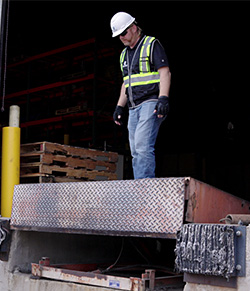 technician standing on mechanical dock leveler