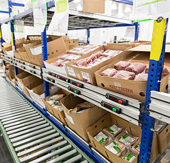 frozen food on a pick-to-light flow rack shelf