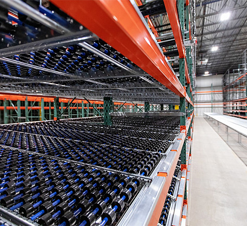 close-up of skatewheel flow rack with conveyor in the background