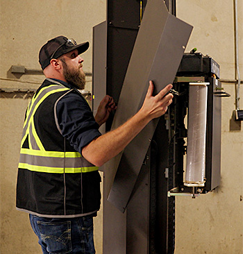 Cisco-Eagle technicians working on a pallet stretch wrapper